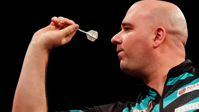 Rob Cross throws a dart