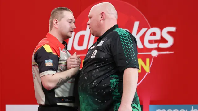 Dimitri Van den Bergh shakes hands with Martin Lukeman