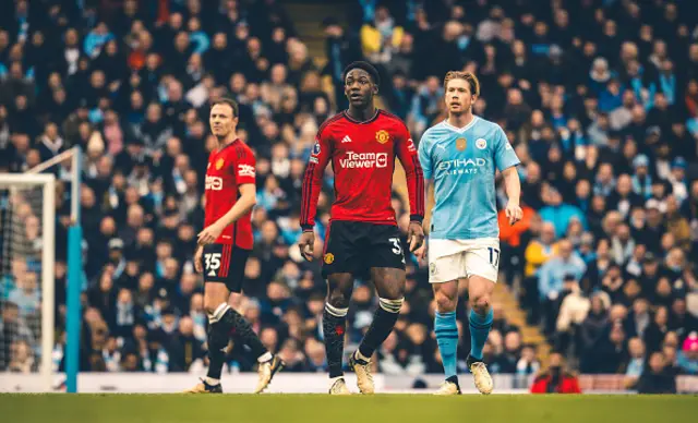 Kobbie Mainoo of Manchester United in action with Kevin de Bruyne