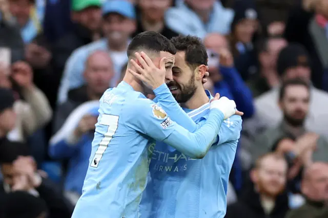 Phil Foden of Manchester City celebrates with Bernardo Silva