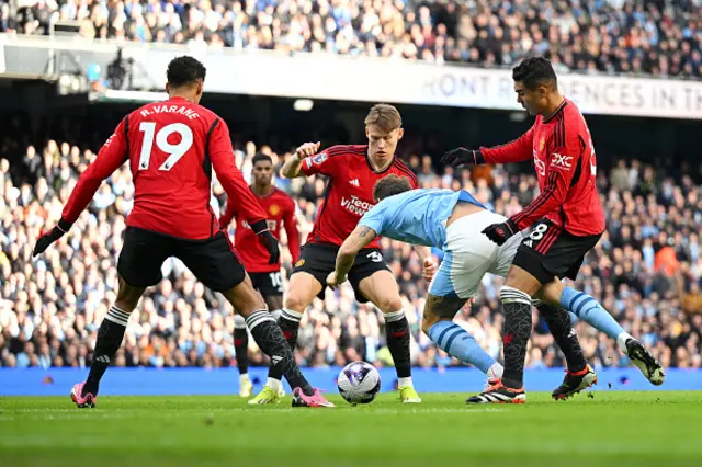 John Stones of Manchester City is challenged in the box by Casemiro