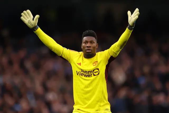 Andre Onana with his arms above his head
