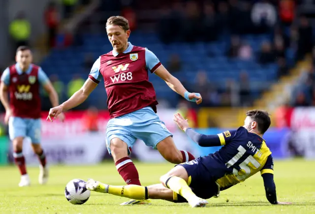 Adam Smith tackles Burnley's Sander Berge