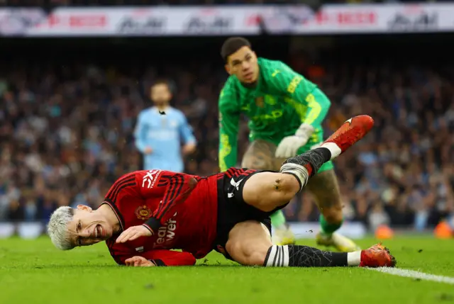 Alejandro Garnacho reacts to being brought down