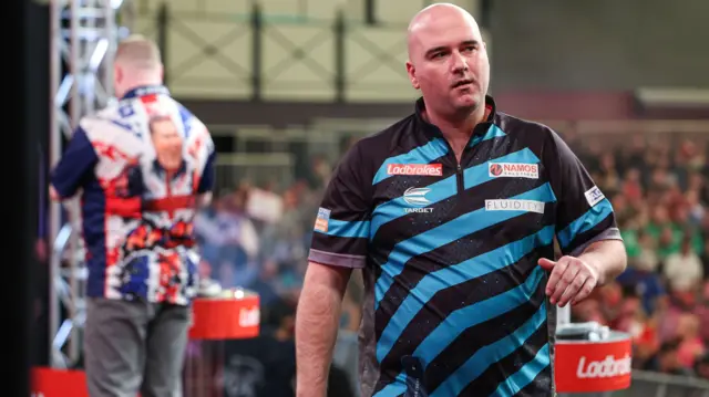 Rob Cross walks off stage