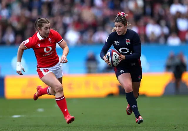 Jess Breach of England breaks with the ball whilst under pressure from Lisa Neumann