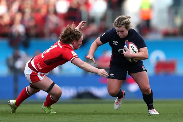 Lark Atkin-Davies of England holds is challenged by Abbie Fleming