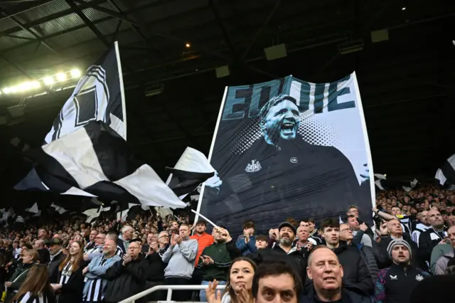 Eddie Howe's face on a flag in the stands before kick off