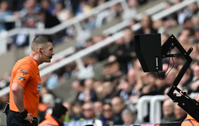 Referee looks at the monitor