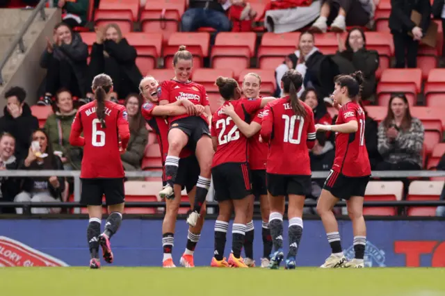 Toone is hoisted into the air after scoring again