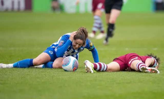 Losada and Ueki lie on the turf after a clash