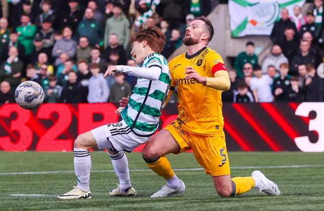 Celtic forward Kyogo Furuhashi is challenged by Livingston defender Mikey Devlin