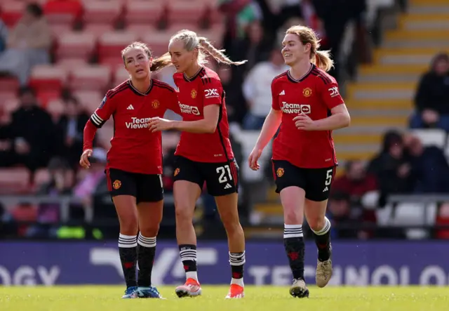Turner celebrates with teammated after her equaliser