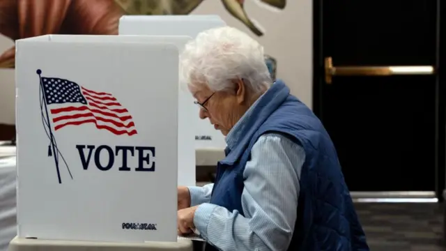 A Colorado voter casts her ballot in 2022