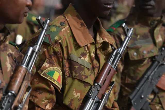 Malian troops stand guard prior to the visit of the French Prime Minister at the Operation Barkane military French base in Gao, Mali, on February 24, 2019.