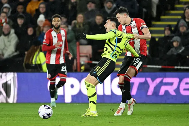 Gabriel Martinelli of Arsenal is pulled back by Anel Ahmedhodzic