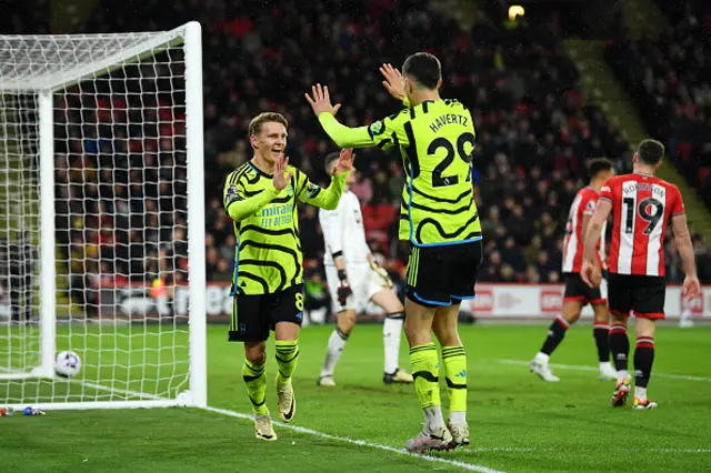 Martin Odegaard of Arsenal (L) celebrates with teammate Kai Havertz