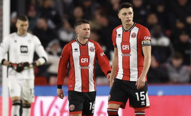 Oliver Norwood and Anel Ahmedhodzic look dejected