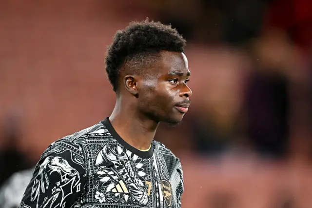 Bukayo Saka looks on during his warm-up