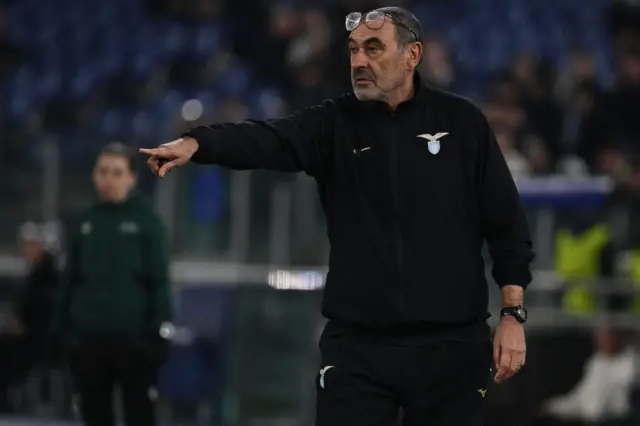 Sarri gives instructions from the sideline with his glasses perched on top of his head.