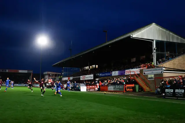 Cheltenham Town playing at home under the lights.