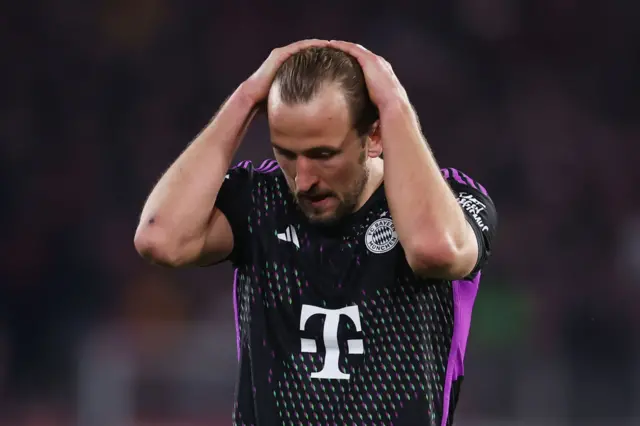 Harry Kane runs his hands through his hair as he cuts a frustrated figure.