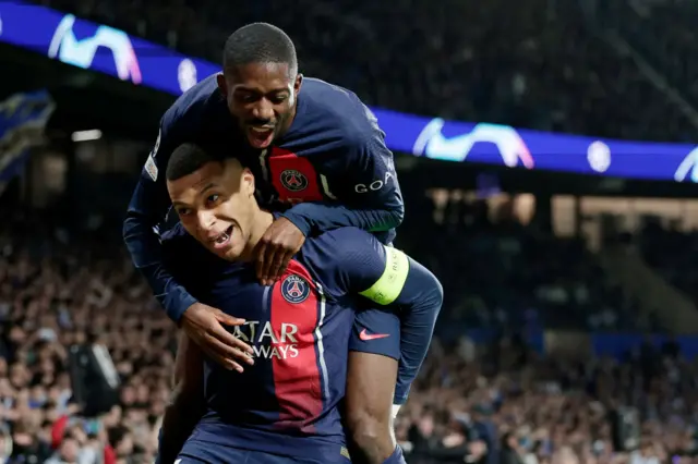 Dembele jumps on Mbappe's shoulders after his opening goal.