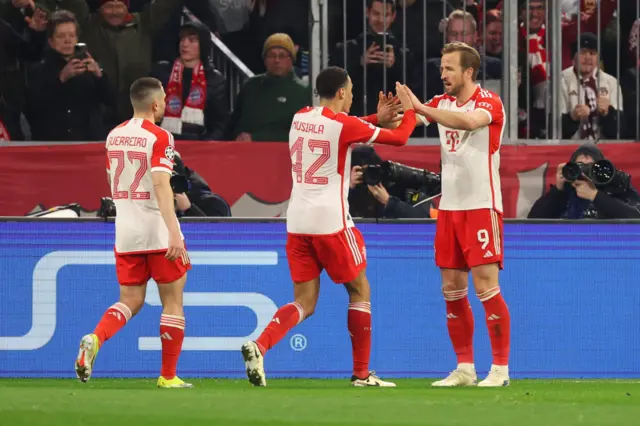 Bayern players congratulate Kane.