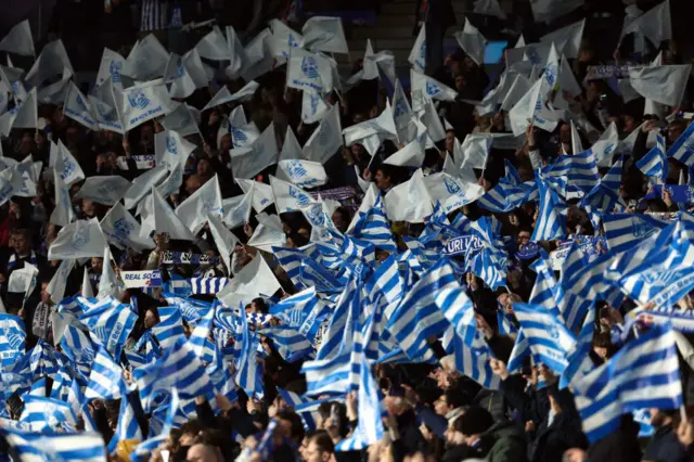 Sociedad wave flags of the teams colours before kick off.