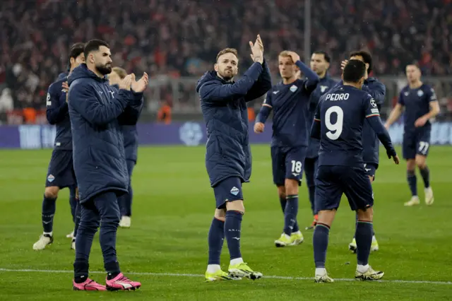 Lazio players applaud the travelling fans after defeat at Bayern.