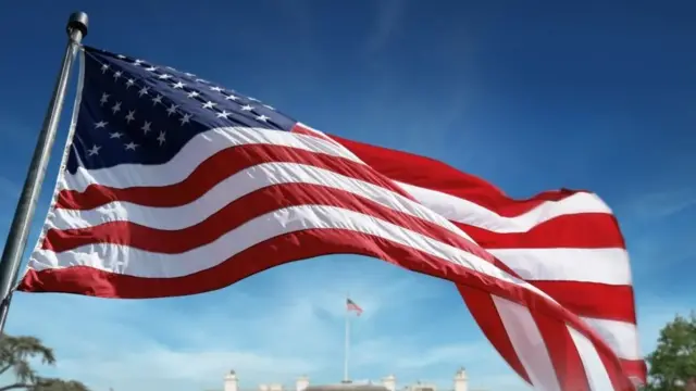 US flag flying in view of the White House in Washington DC, USA