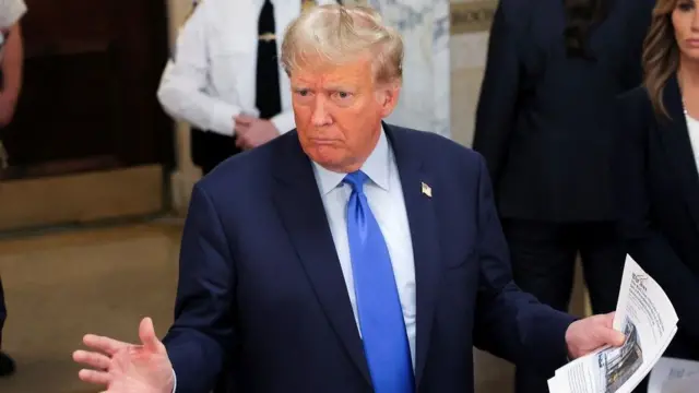 Former U.S. President Donald Trump gestures as he makes a statement to the media outside a Manhattan court room