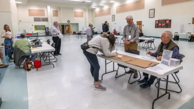 Voters gather in a room in the church to cast their ballots