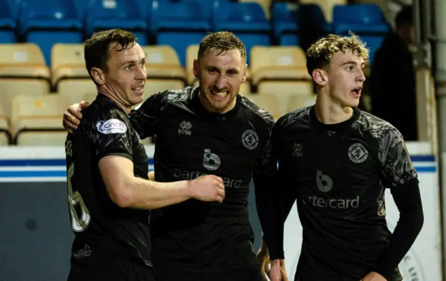 Dundee United's Louis Moult celebrates with Jordan Tillson and Miller Thomson after scoring to make it 1-0 during a cinch Championship match between Greenock Morton and Dundee United