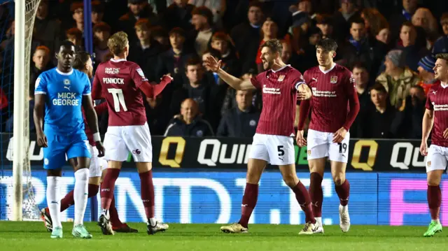 Northampton Town defender Jon Guthrie (5) celebrates opening the scoring during the League One match between Peterborough United and Northampton Town