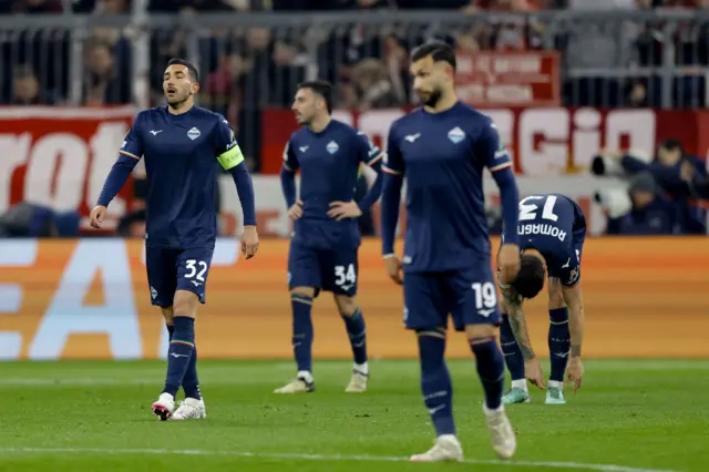 Lazio player stand stunned after conceding before half time.