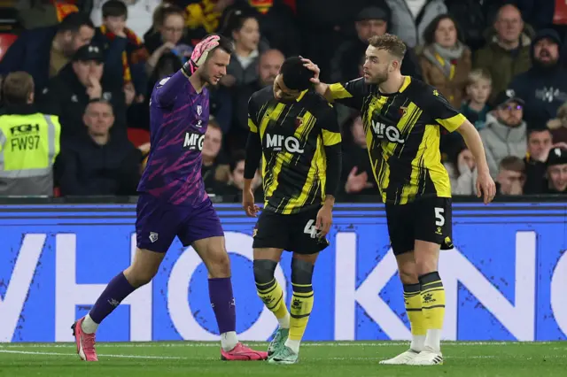 Watford players react after scoring own goal