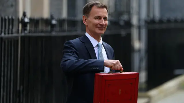 Jeremy Hunt poses with the red budget box outside his office on Downing Street