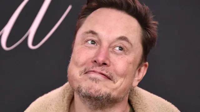 Elon Musk poses for cameras at an awards show