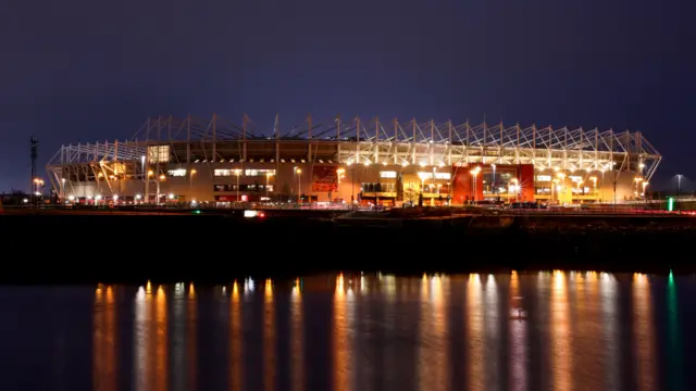 Riverside Stadium lit up at night