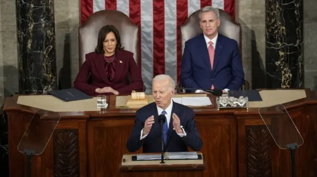 President Joe Biden sits in front of the vice-president and House of Representatives speaker