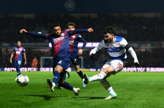 Ilias Chair of Queens Park Rangers crosses the ball under pressure from Darnell Furlong of West Bromwich Albion