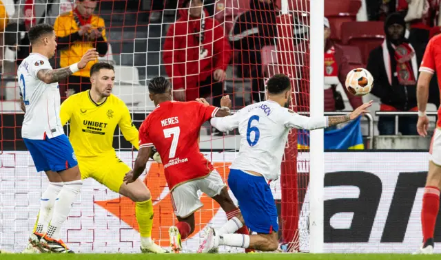 Connor Goldson and Benfica's David Neres in action