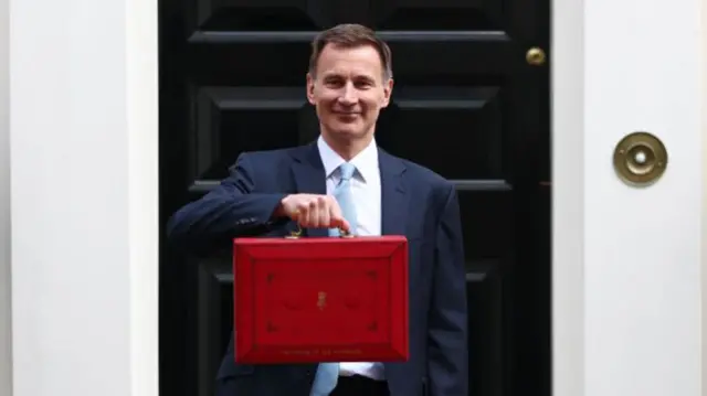 Hunt holds the red box outside 11 Downing Street