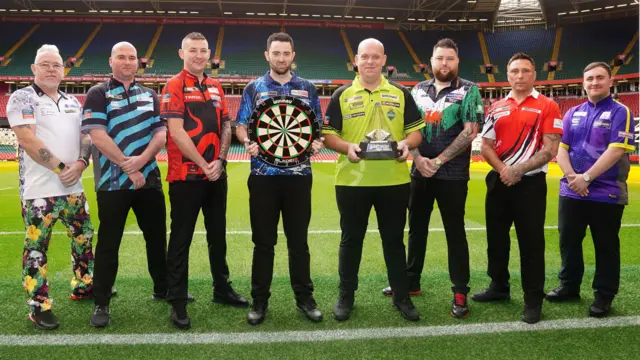 The eight players pose for a photograph at the Premier League Darts launch in Cardiff