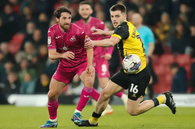 Joe Allen of Swansea City challenged by Giorgi Chakvetadze of Watford