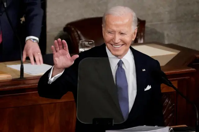 Biden smiles as he cracks a joke