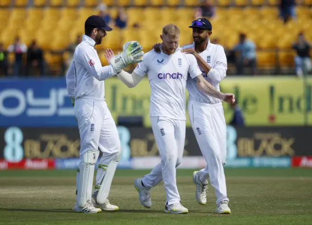 Ben Stokes is congratulated by team-mates after dismissing Rohit Sharma