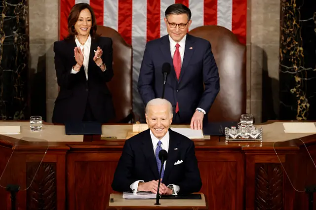 Biden smiling at the podium