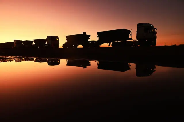 A row of lorries at the border between the two countries.